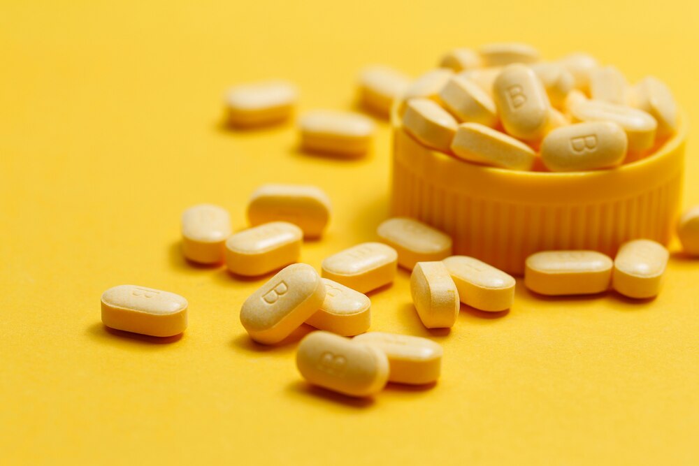 vitamin B tablets on yellow background
