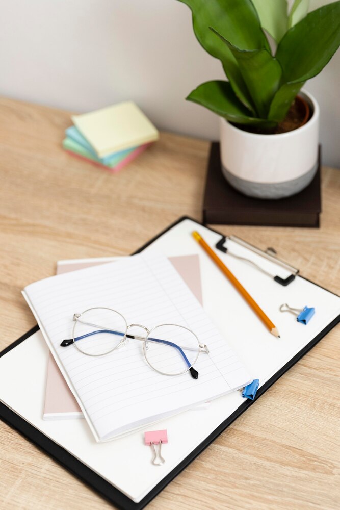 Close up clipboard and glasses