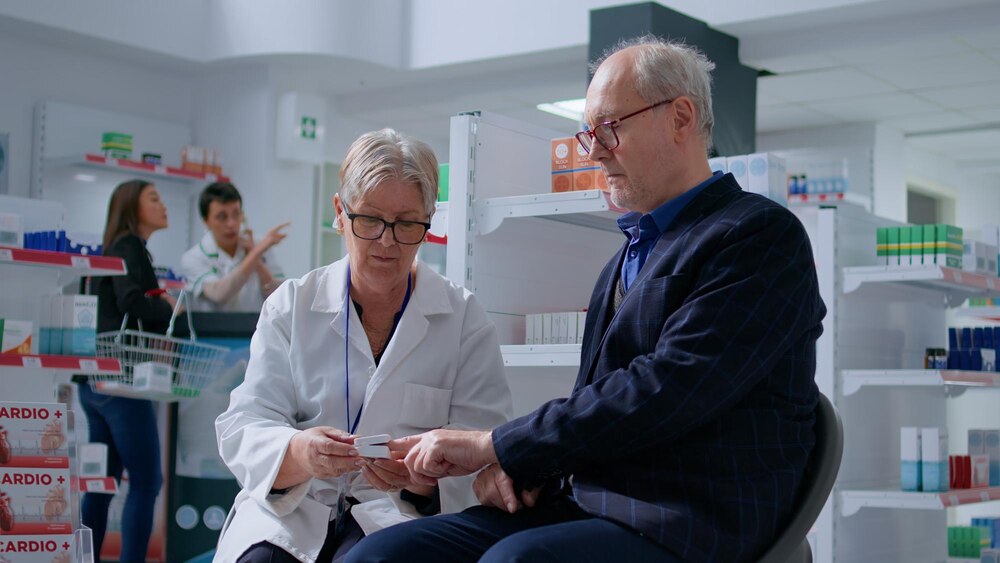 Elderly pharmacist using pulse oximeter